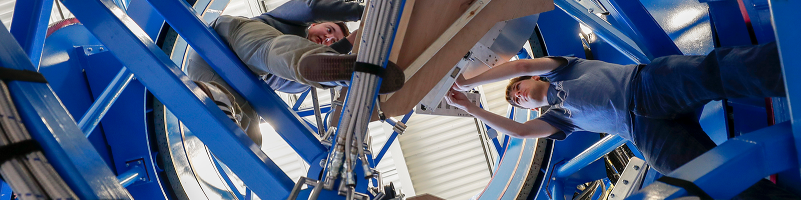 CSE students working on a telescope.